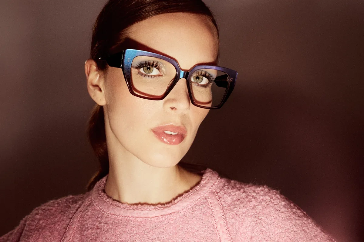 A woman wearing the eyewear model Andromeda from Studio Eyewear